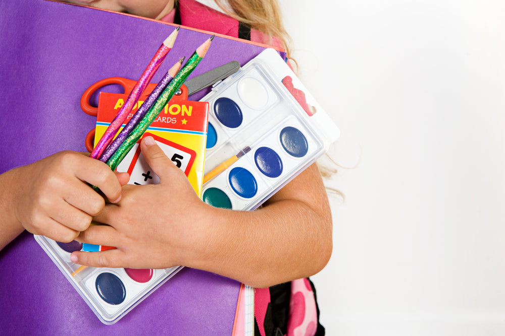 child-hugging-school-supplies.jpg